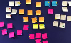 A wall of Post-It sketches after a session